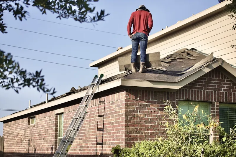 Professional roofer working on a residential roof in Forest Court
